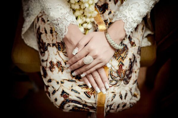 A woman with her hands on top of her dress.