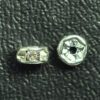 A pair of silver beads sitting on top of a table.