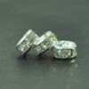 A close up of three silver beads on top of a table.