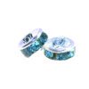 A pair of blue and silver beads sitting next to each other.