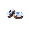 A pair of brown and white beads sitting on top of a table.