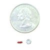 A coin and some small red objects on top of it.