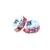 A pair of pink and purple beads sitting next to each other.