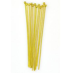 A bunch of yellow plastic toothpicks on top of each other.