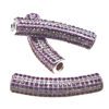 A pair of purple and silver beads sitting on top of a table.