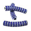 A pair of blue and silver beads sitting on top of a table.
