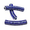 A pair of blue and silver beads sitting on top of a table.