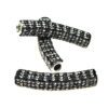 A pair of black and white beads sitting on top of each other.