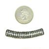 A coin and some beads are next to each other