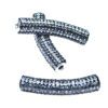 A pair of silver beads with black and white diamonds.