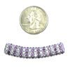 A coin and some beads are next to each other