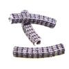 A pair of motorcycle grips with purple and white rhinestones.