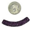A small coin and some purple beads