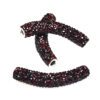 A pair of red beads are sitting on top of each other.