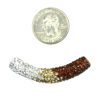 A small coin and some beads are next to each other