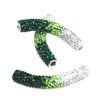 A pair of green and white beads sitting on top of each other.