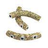 A pair of gold colored metal beads with white eyes.