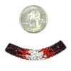A coin and some beads are next to each other