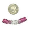 A coin and some pink and white beads