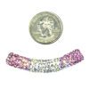 A coin and some beads are next to each other