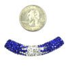 A coin and some blue and white beads