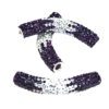 A pair of purple and silver beads sitting on top of a white surface.