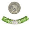 A coin and some green and white beads