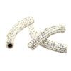 A pair of white beads with the letter k on it.