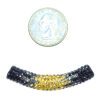 A small coin and some beads are next to each other