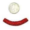 A red bead is sitting next to a penny for size.