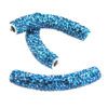 A pair of blue beads are sitting on top of each other.