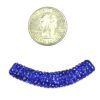 A small coin and some beads are on the table.