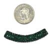 A small coin and some green beads