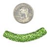A green bead is next to a coin and a coin