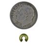 A coin and some gold colored beads next to each other.