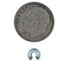 A coin and some metal parts on a white background
