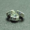 A close up of three silver colored beads