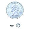 A coin and some small parts on top of it.