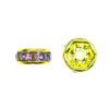 A yellow bead with pink and purple stones.