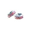 A pair of pink and silver earrings sitting next to each other.