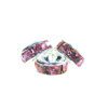 A group of three pink and white bracelets.