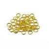 A pile of gold colored jump rings on top of each other.