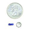A coin and some blue beads on top of it