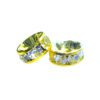 A pair of yellow and silver beads sitting on top of a table.