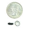 A coin and some small parts next to it