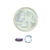 A coin and some beads are next to each other.