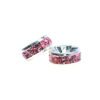 A pair of pink rhinestone spacers sitting next to each other.