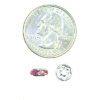 A coin and some beads are next to each other.