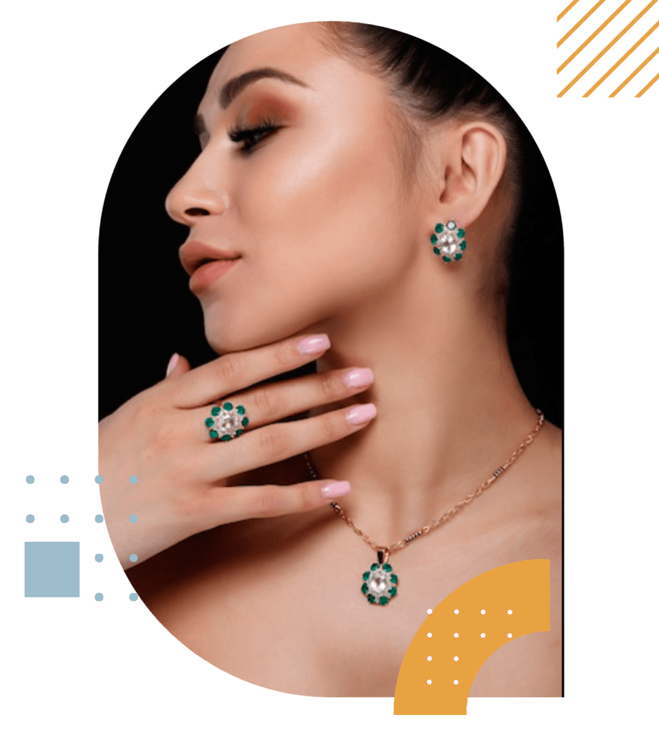 Woman showcasing a necklace and earrings with green gemstones, accentuated by a stylish makeup look, against a green and abstract background.