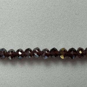 Row of dark brown faceted beads.